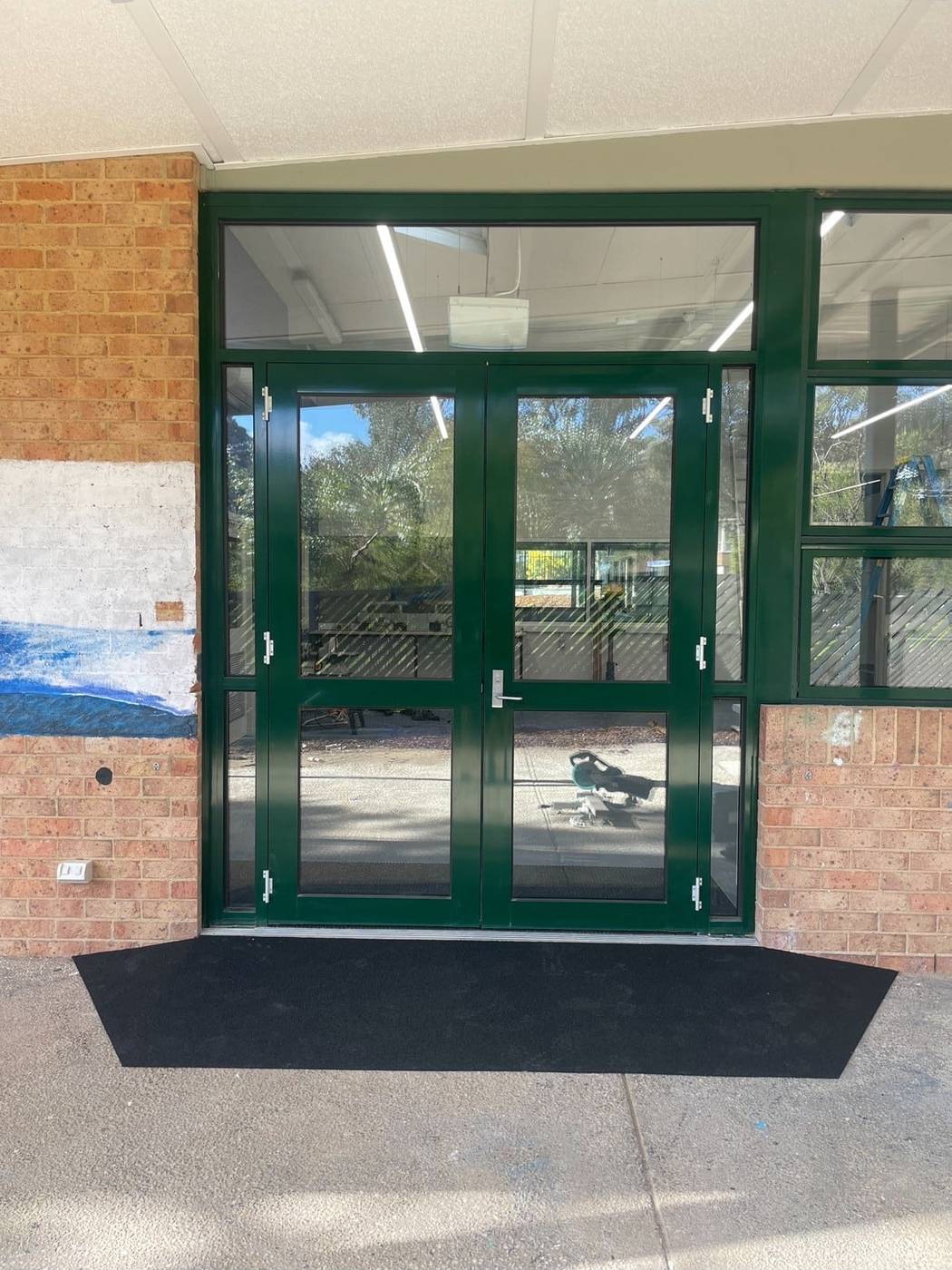 Commercial double-door access ramp Commercial rubber access ramp at a school double-door entrance