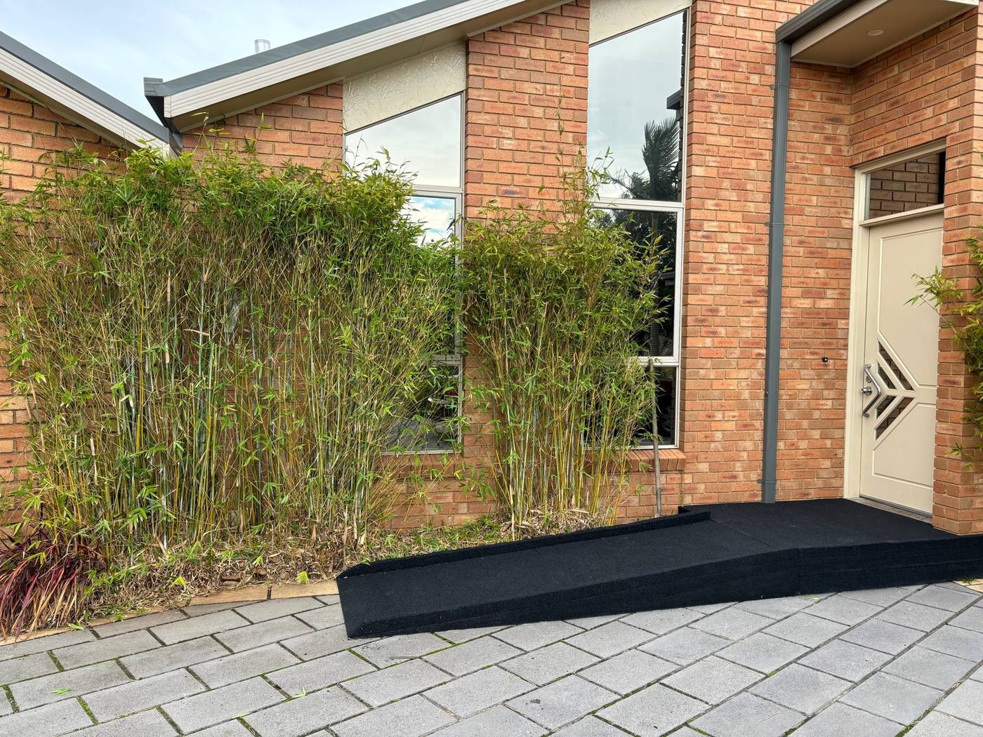 Front door rubber ramp – side view Side view of a rubber disability ramp leading to a front door