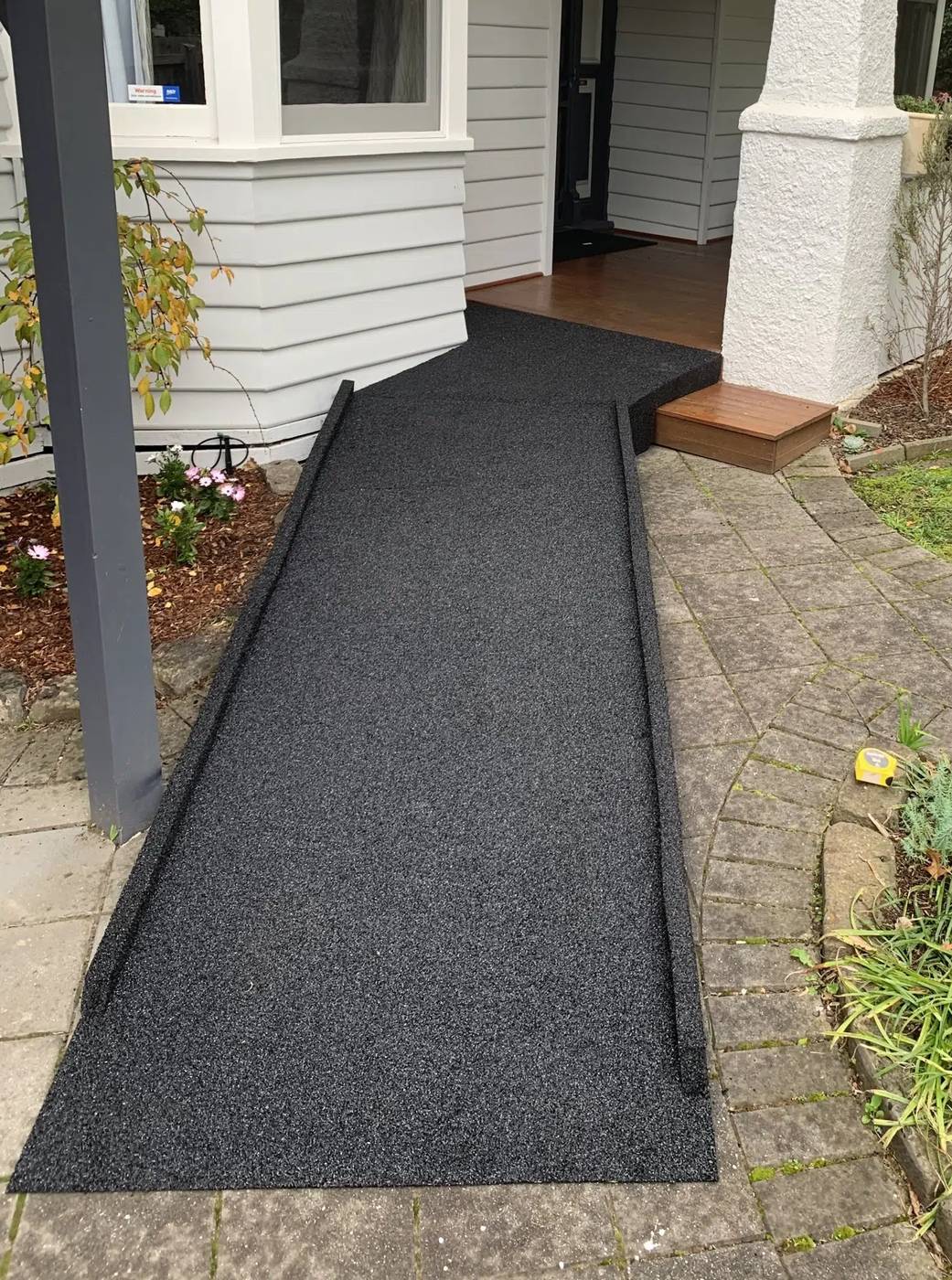 Long custom rubber access ramp running beside a verandah post to the front porch