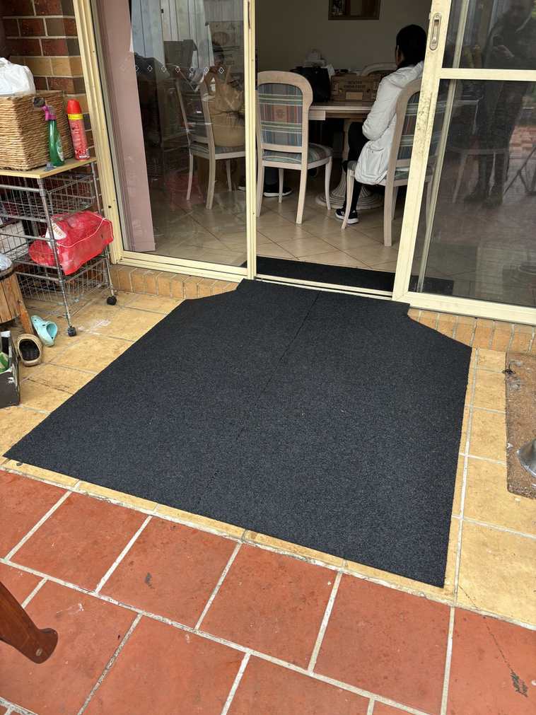 Rubber landing platform at sliding door Large rubber landing platform outside a sliding door on terracotta tiles