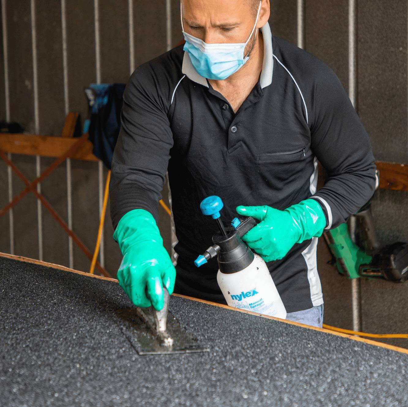 Technician spraying and trowelling a rubber ramp at the Melbourne factory