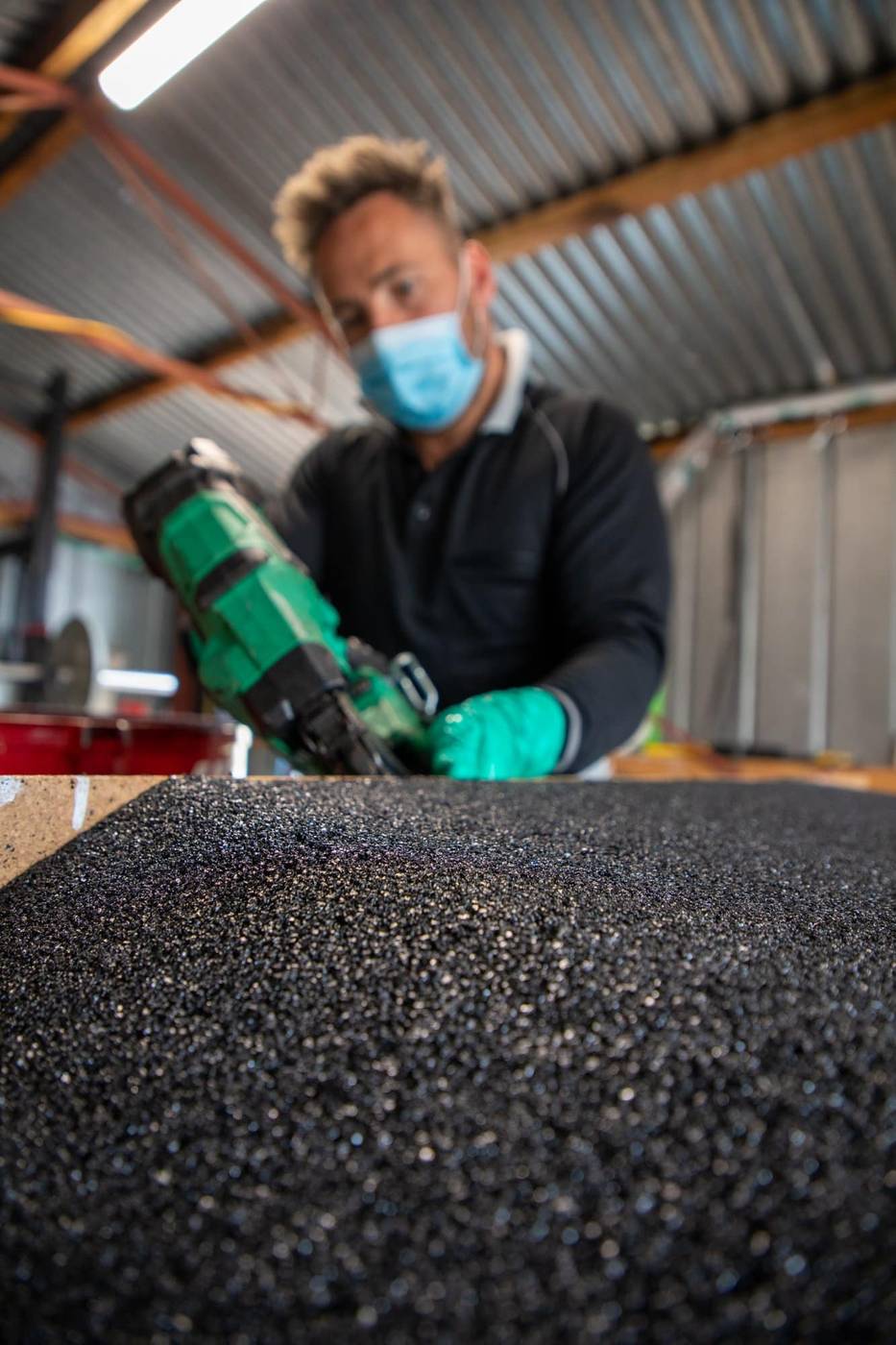 Ramps R Us technician building a recycled rubber ramp in the Mentone workshop