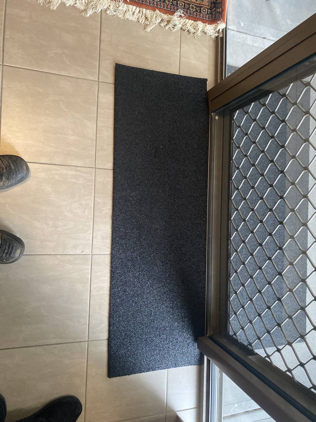 Narrow rubber ramp fitted against a security sliding door frame